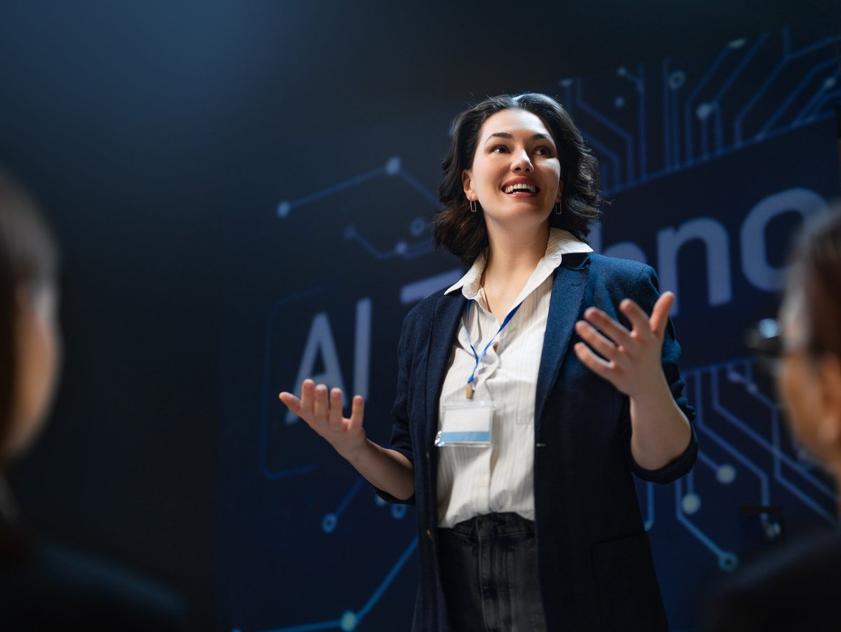 Empowering image of a confident female professional presenting groundbreaking AI concepts at a technology conference.